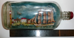 Three-masted sailing ship in full sail, in a bottle, with a blue background, a village, Canadian airplane, surfaced U-boat