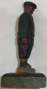 Item 455 View 2 of 4 Wooden carving of a PoW in navy coat, right side (Photo credit R J Henderson)